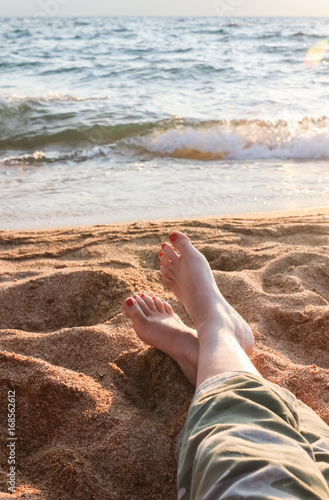 Closeup of Womans Legs and Feet at the Beach