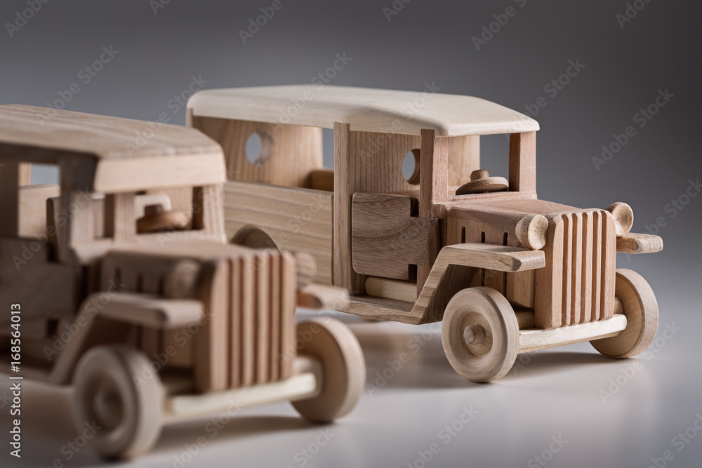 Miniature wooden retro bus in the studio, mirroring.
