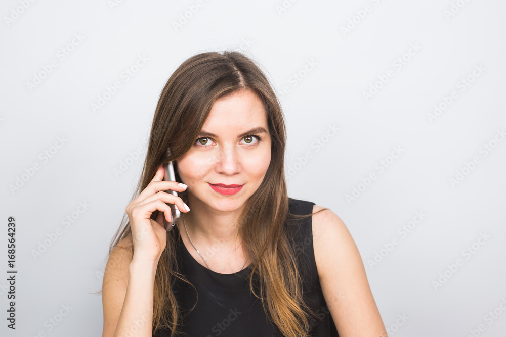 beautiful young woman speaks talking by mobile phone, on a white background beautiful young woman speaks talking by mobile phone, on a white background