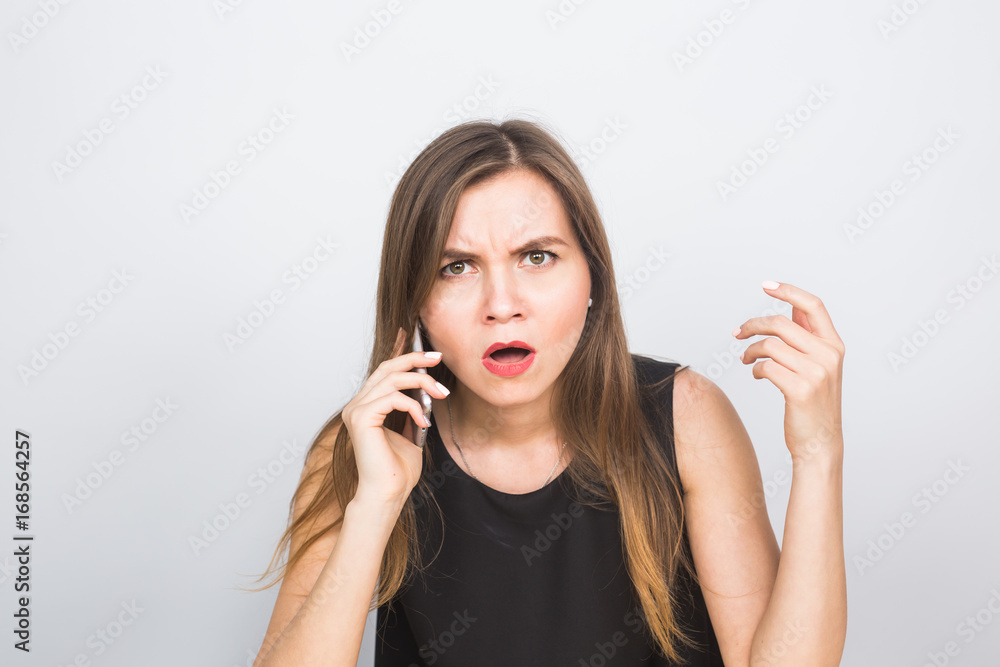 Surprised young businesswoman talking on the mobile phone Surprised young businesswoman talking on the mobile phone