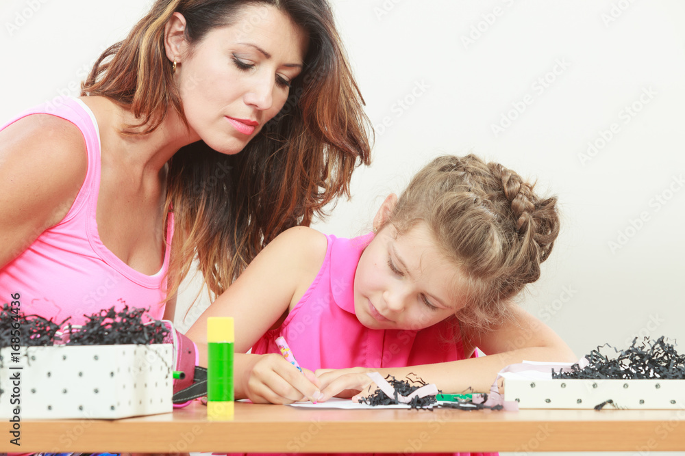 Fototapeta premium Mom helping daughter with homework