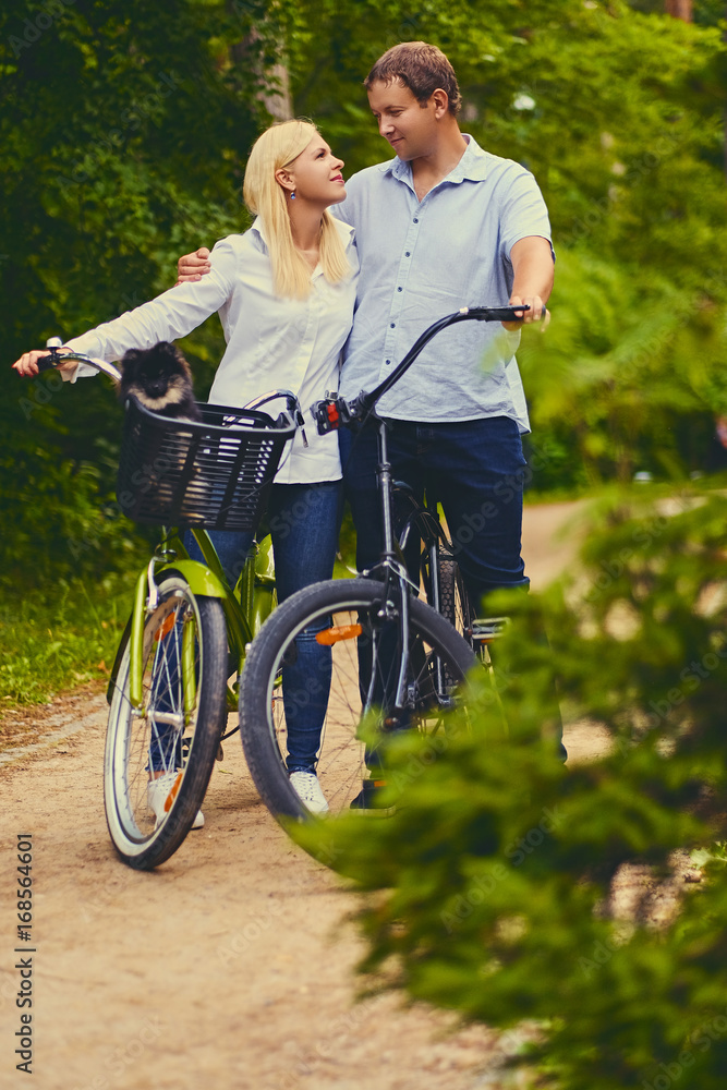 A man and a woman on a bicycle ride.
