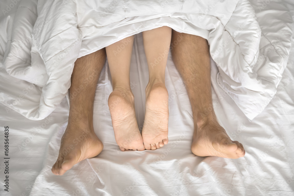 Legs of lovers under blanket Legs of lovers under blanket
