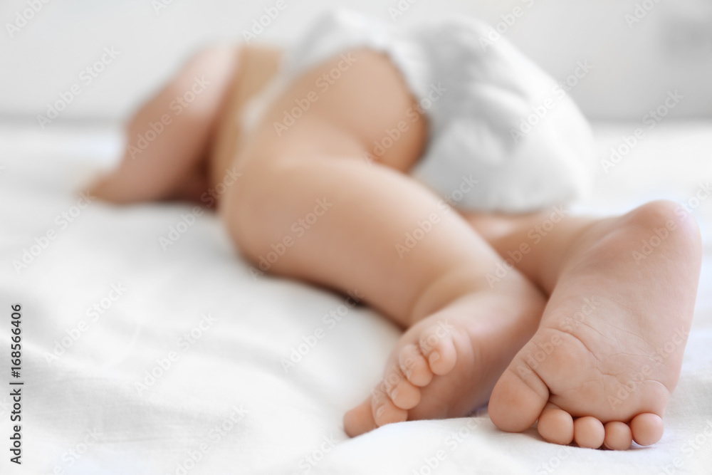 Cute little baby sleeping on bed at home