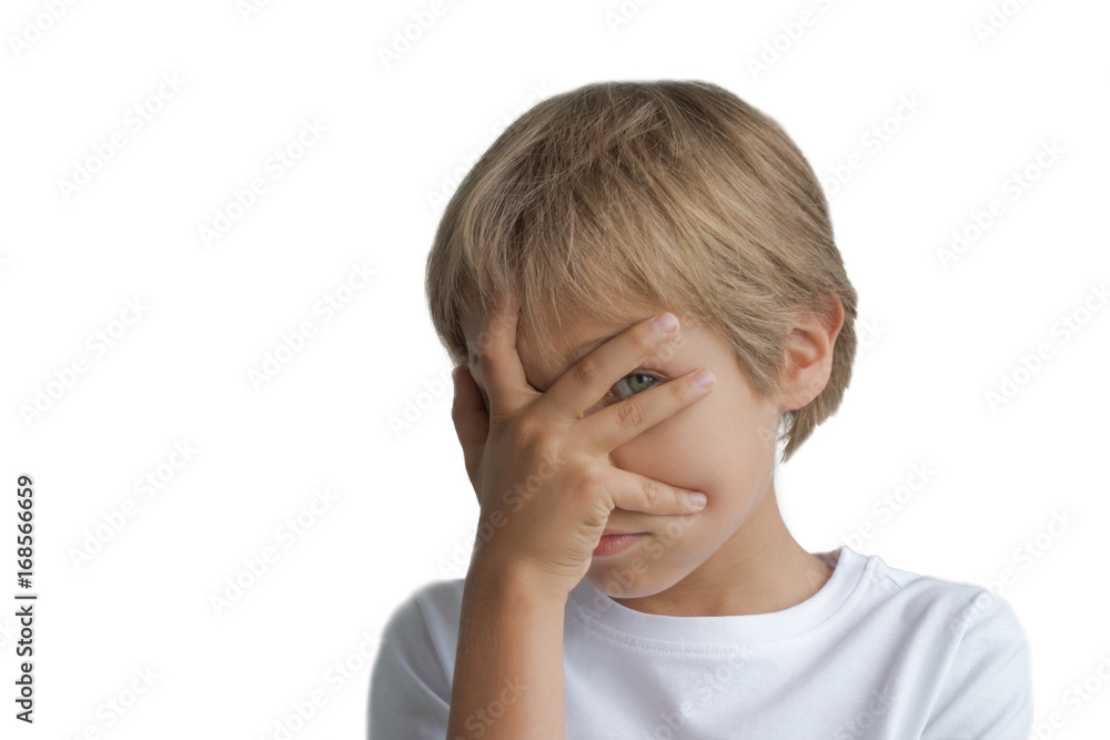 Boy covering his face with hand and looking at camera through fingers isolated on white background Boy covering his face with hand and looking at camera through fingers isolated on white background