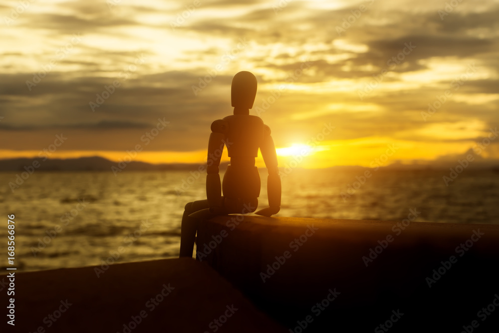 Silhouettes of wooden models feel lonely at sunset.