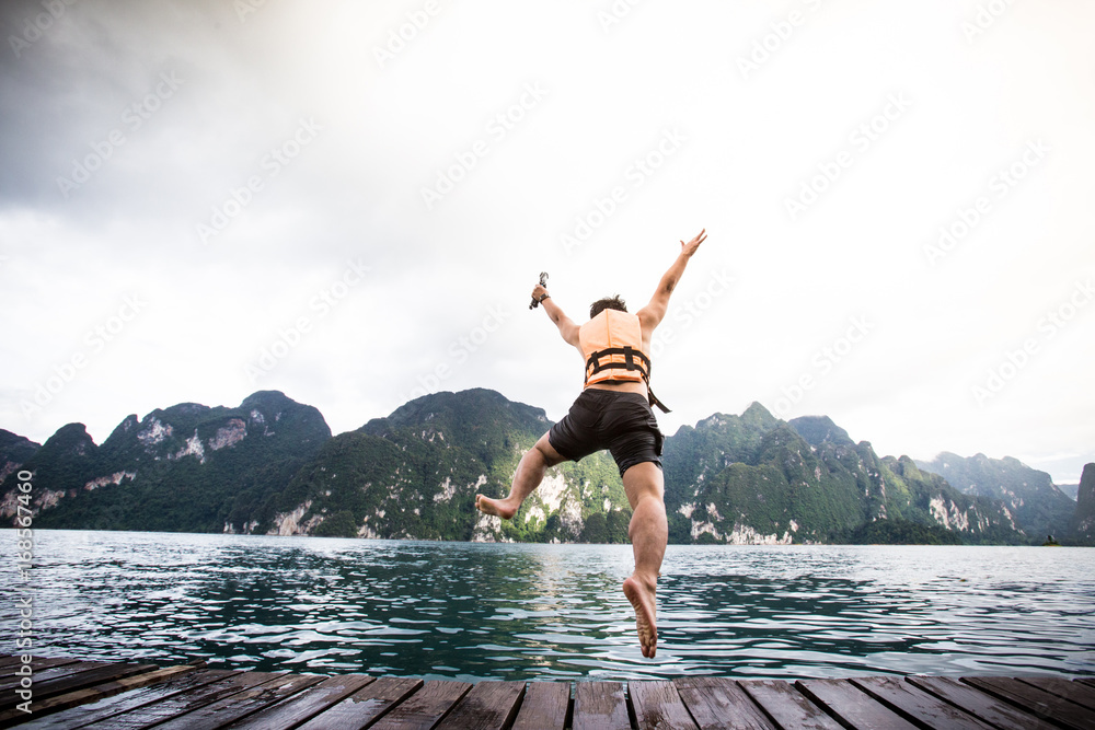 A man is jumping in to the water.