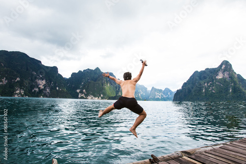 A man is jumping in to the water.