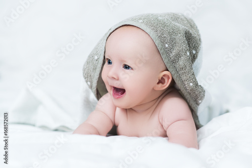 Baby girl or boy after shower with towel on head