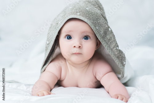 Baby girl or boy after shower with towel on head