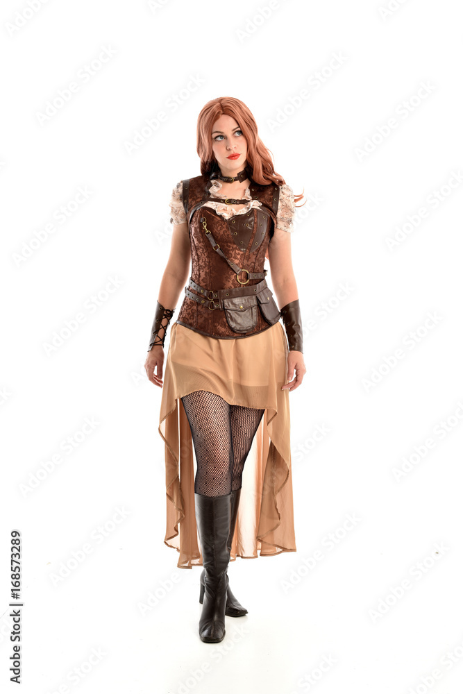 full length portrait of a red haired lady, wearing a steampunk inspired outfit, isolated on white background. full length portrait of a red haired lady, wearing a steampunk inspired outfit, isolated on white background.