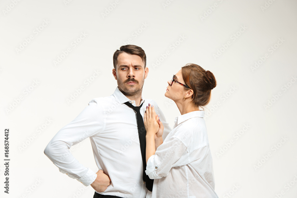 The young man and beautiful woman in business suit at office on white background The young man and beautiful woman in business suit at office on white background