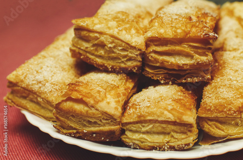 Puff pastry cakes with sugar powder close up