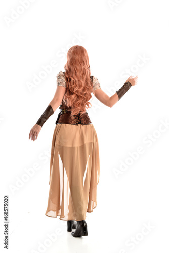 full length portrait of a red haired lady, wearing a steampunk inspired outfit, isolated on white background.