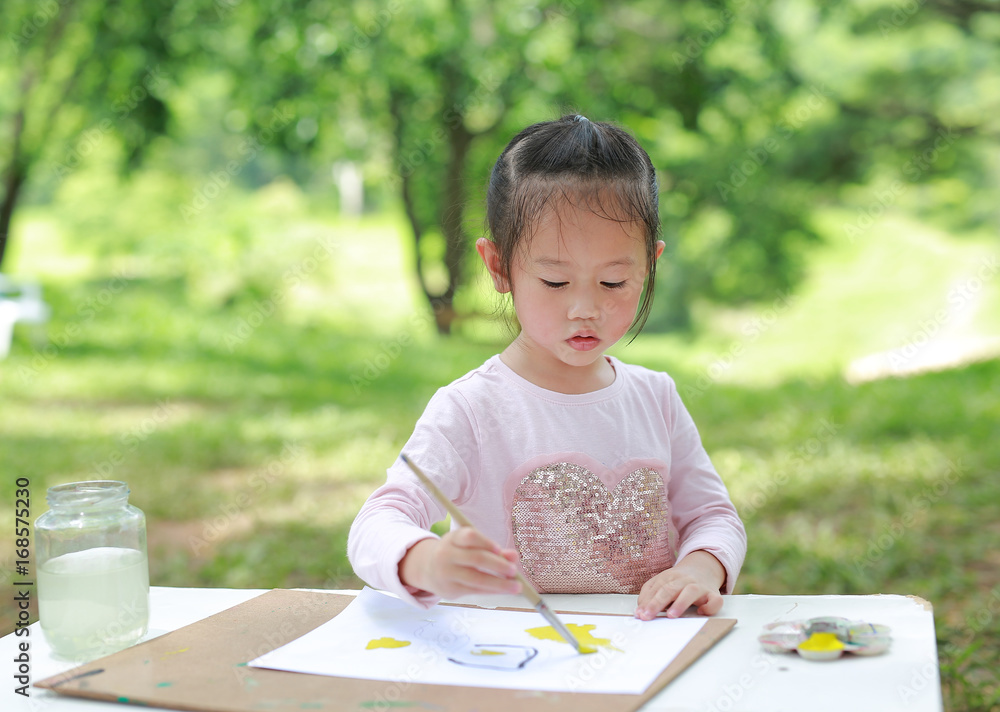 Cute little girl with painted hands in the park, Education art concept. Cute little girl with painted hands in the park, Education art concept.