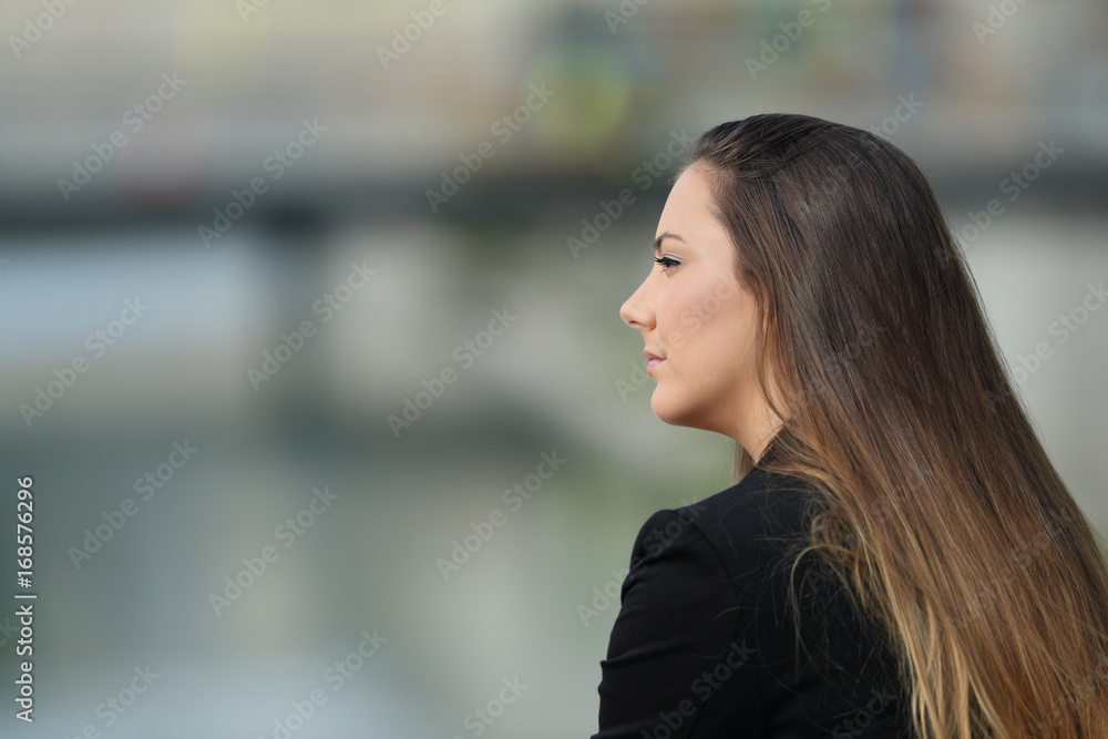 Pensive executive looking at side outdoors Pensive executive looking at side outdoors