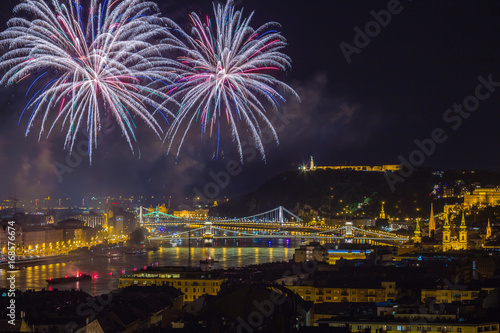 Budapest  Hungary - 20th of August fireworks on St. Stephens or foundation day of Hungary. This view includes the Hungarian Parliament  Liberty Statue  Gellert Hill  Citadell and Chain Bridge