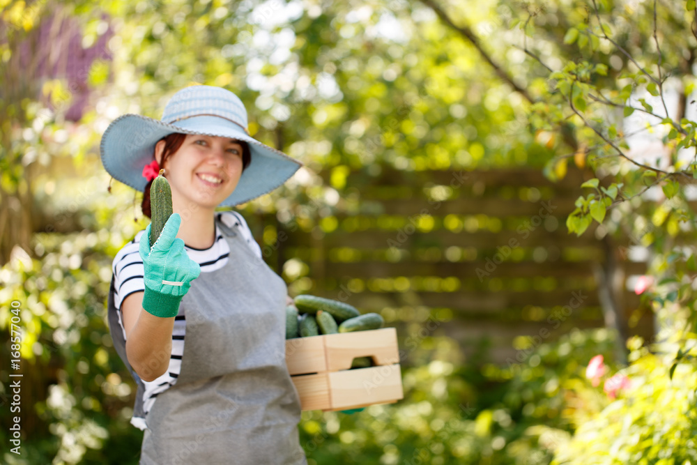 Farmer in hat with cucumber