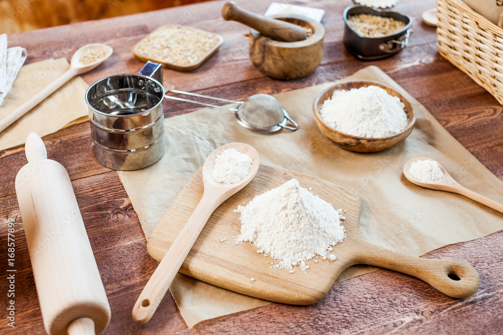 wheat and flour on rustic wooden table wheat and flour on rustic wooden table