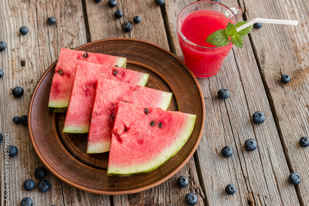 Watermelon juice on a wooden table. It can be used as a background Watermelon juice on a wooden table. It can be used as a background