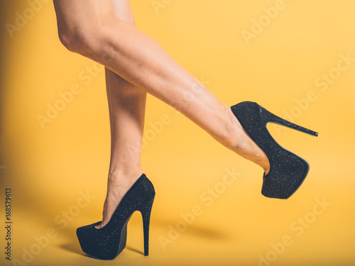 Sexy legs of woman wearing black heels photo
