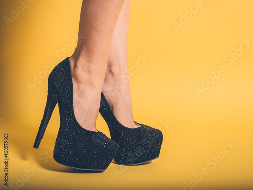 Sexy legs of woman wearing black heels photo