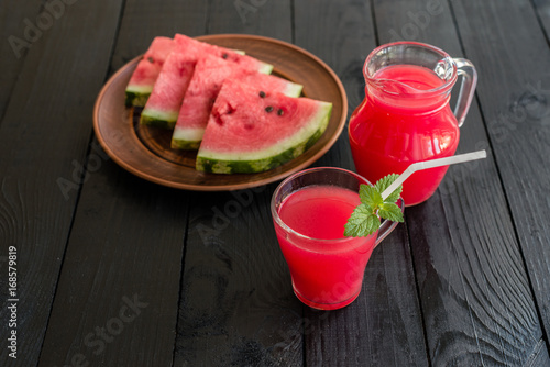 Watermelon juice on a wooden table. It can be used as a background