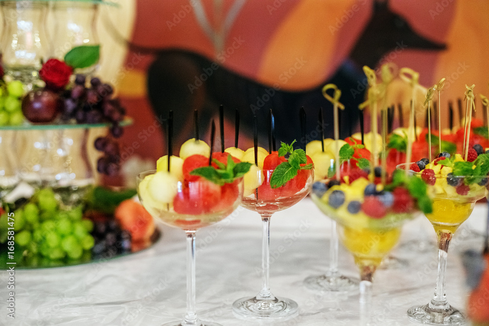 Fruit salad with watermelon and melon. Refreshing mint. The concept is healthy food, holiday, restaurant, catering.