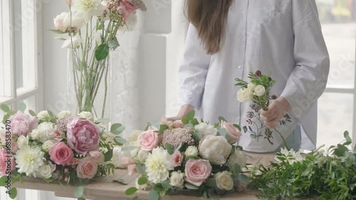 Business, sale and floristry concept - florist woman making bunch at flower shop
