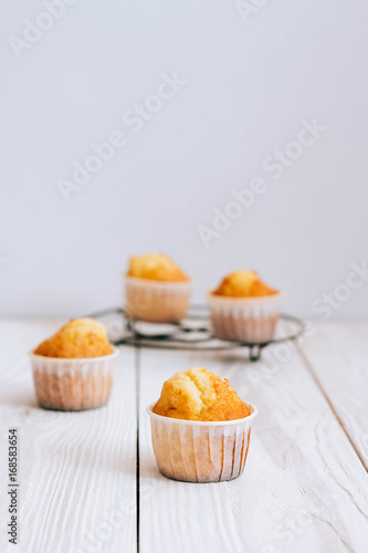 Orange muffins on a white wooden background, minimalism