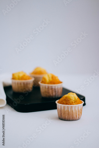 Orange muffins on a white background, minimalism