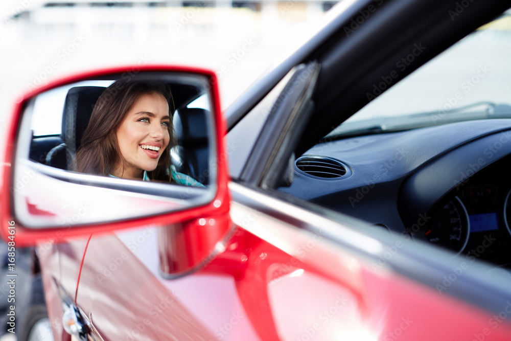 Girl looking at rearview mirror Girl looking at rearview mirror