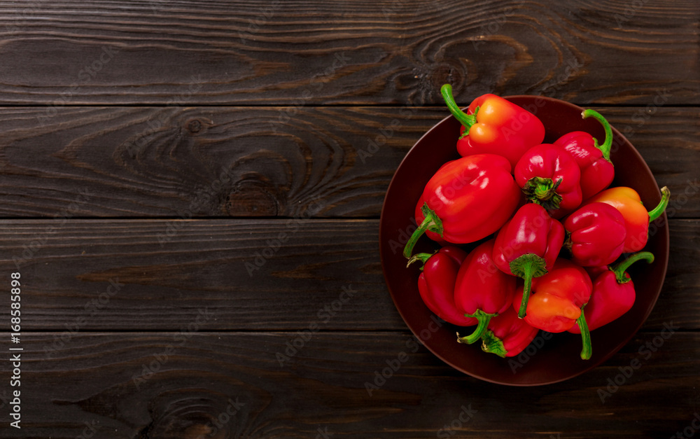 Sweet bulgarian red peppers on a dark wooden background. Sweet bulgarian red peppers on a dark wooden background.