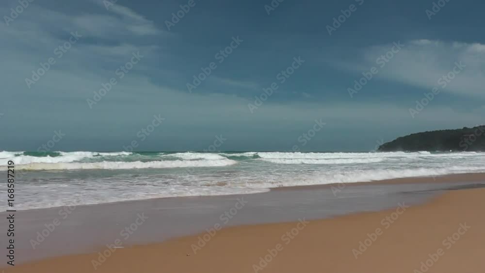Sandy beach on the shore of the warm azure sea Sandy beach on the shore of the warm azure sea
