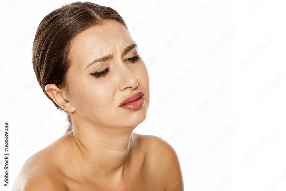 Portrait of sad young woman on white background Portrait of sad young woman on white background