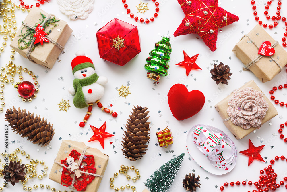 Christmas background with decorations. New Year symbol - decorative fir tree. Gifts in craft paper, pine cones, red hearts and confetti. Flay lay, top view. Christmas background with decorations. New Year symbol - decorative fir tree. Gifts in craft paper, pine cones, red hearts and confetti. Flay lay, top view.