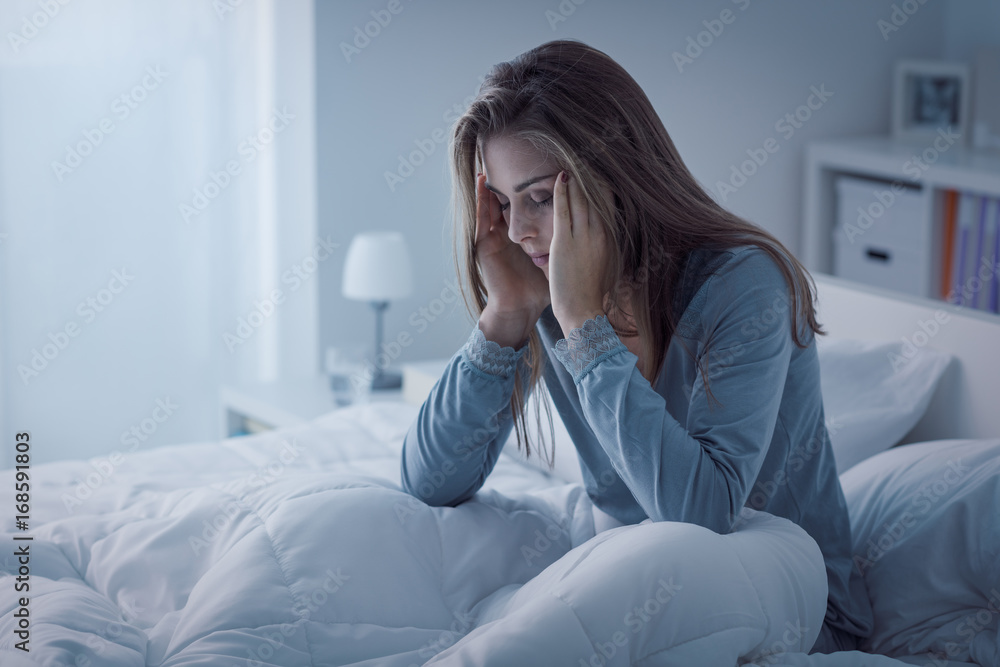 Depressed woman awake in the night, she is exhausted and suffering from insomnia Depressed woman awake in the night, she is exhausted and suffering from insomnia