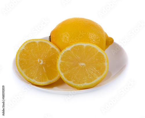 lemon in white plate isolated on white background photo