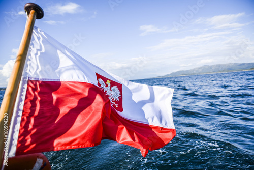 Polish flag waving while sailing on a yacht in the north sea photo