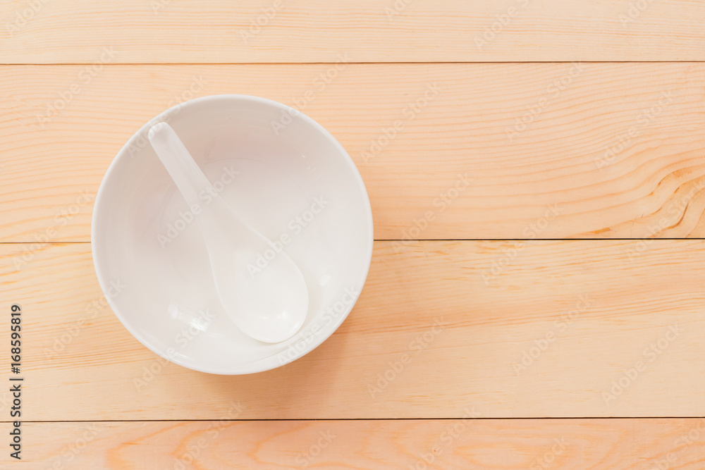 Empty white bowl on wood desk,Top view Empty white bowl on wood desk,Top view