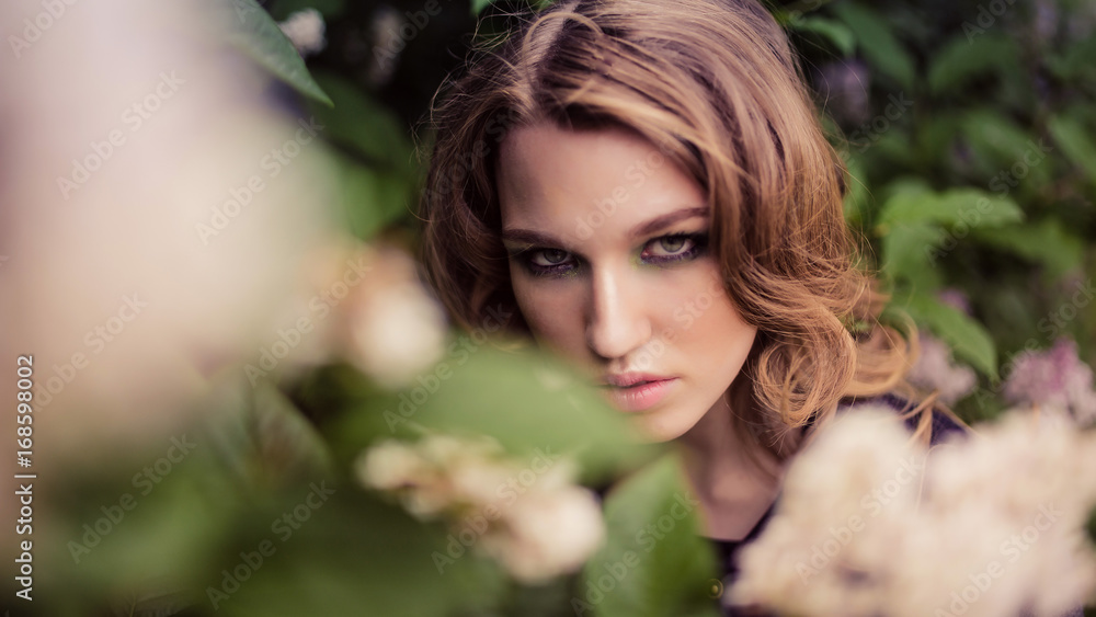 Portrait of relaxed young lady in a summer park waiting. Beautiful young girl with blonde curly hair , outdoor. Portrait of relaxed young lady in a summer park waiting. Beautiful young girl with blonde curly hair , outdoor.