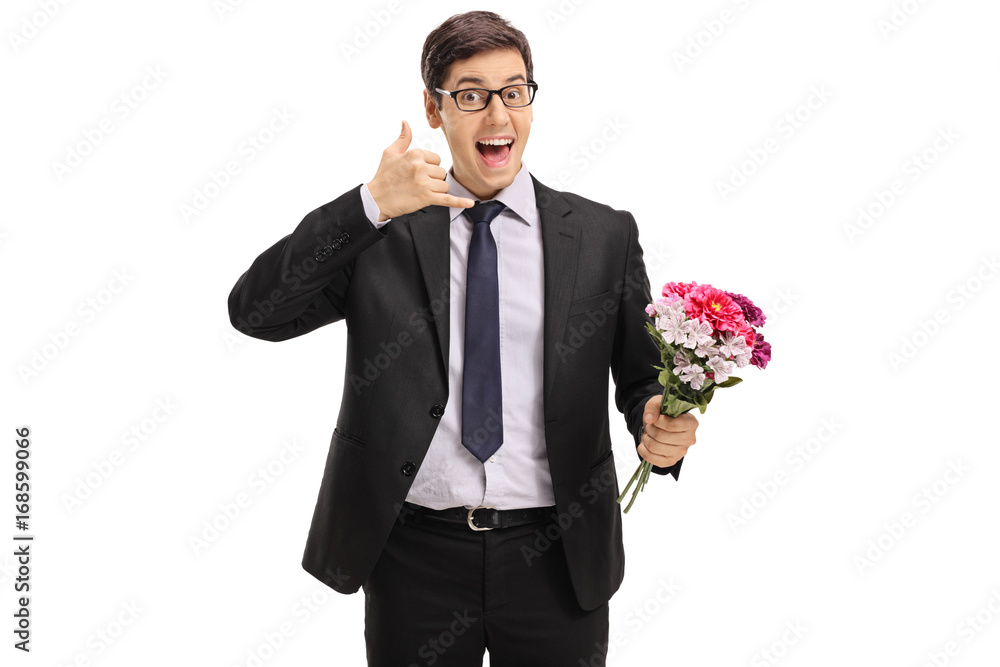Cheerful businessman with flowers making a call me gesture Cheerful businessman with flowers making a call me gesture