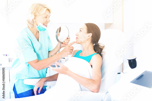 Doctor beautician discussing with woman