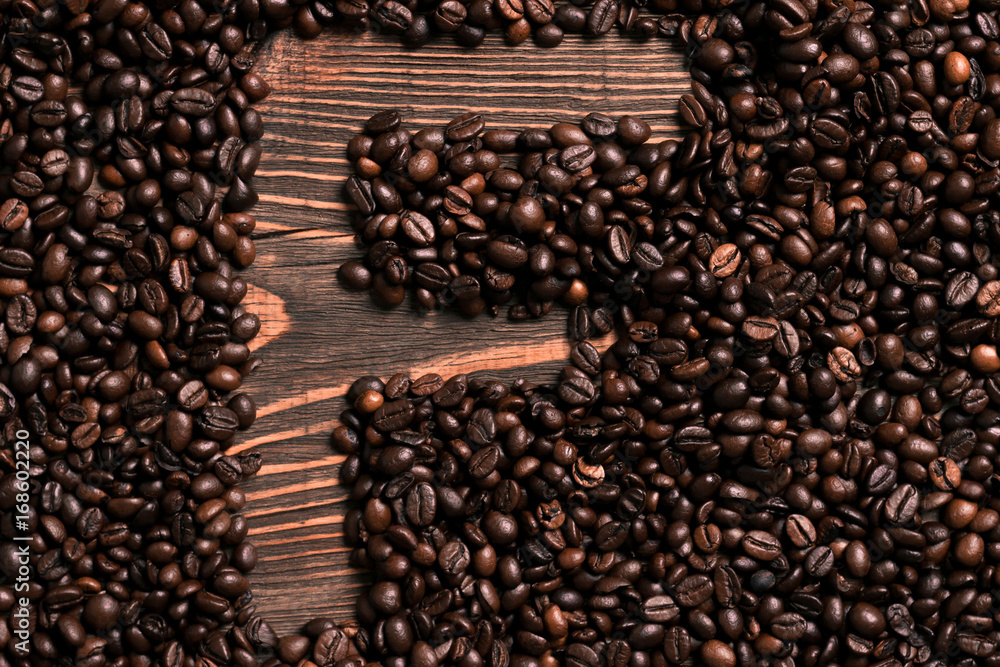 Fototapeta premium Letter F inscription with coffee bean on the wooden table