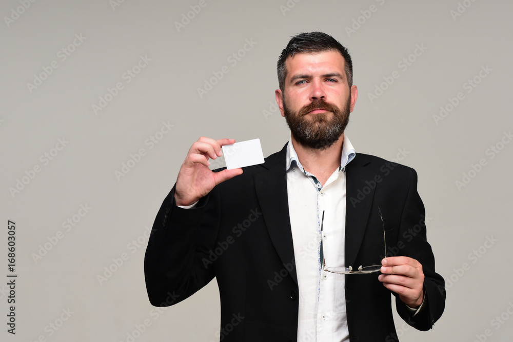 Man in suit with beard holds white business card Man in suit with beard holds white business card