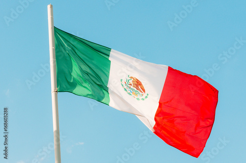Waving colorful Mexico flag on blue sky
