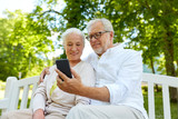 senior couple with smartphone taking selfie 