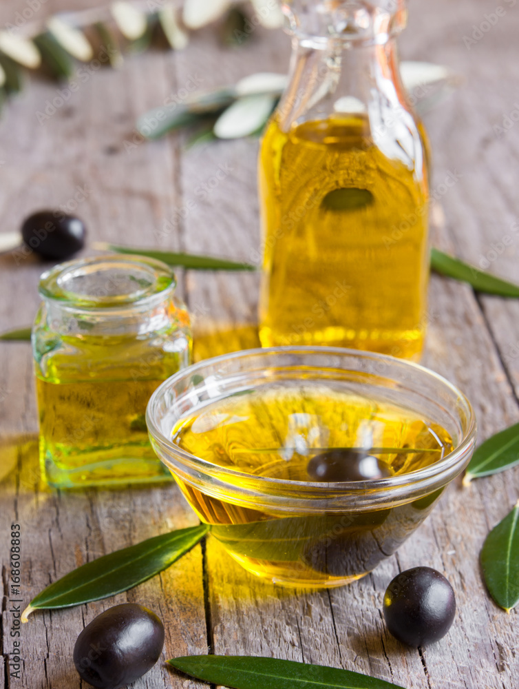 Olive oil in a glass bottle and bowls Olive oil in a glass bottle and bowls