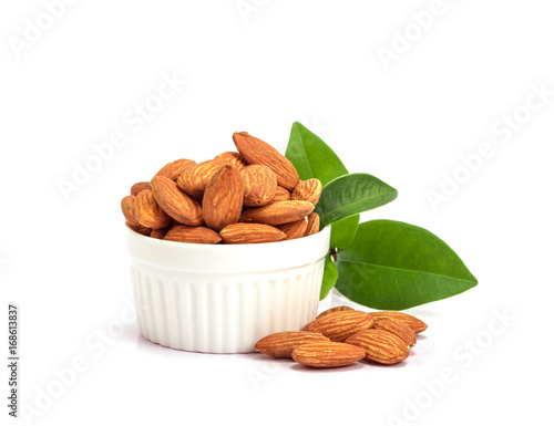 the fresh almonds in white cup on white background