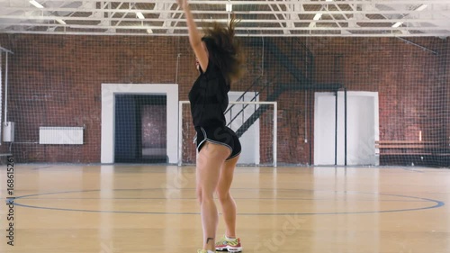 Young woman in black clothes dancing twerk photo